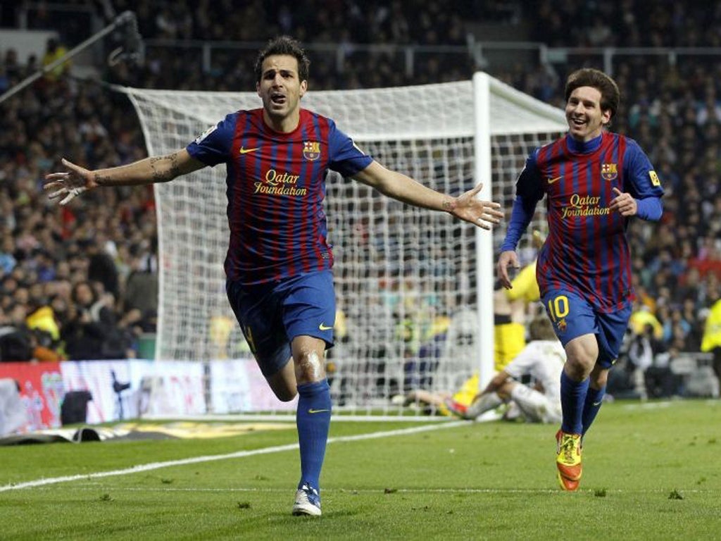 Cesc Fabregas (left) celebrates with teammate Lionel Messi
