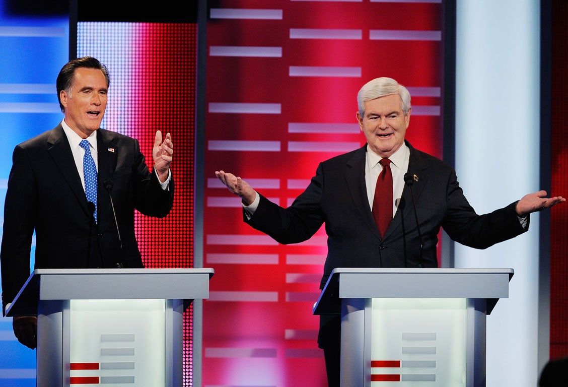Mitt Romney (L) attacks former speaker of the House Newt Gingrich during the ABC News GOP Presidential debate
