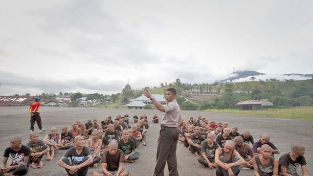 A police officer lectures a group of detained Indonesian punks at a police school in Aceh Besar in Aceh province