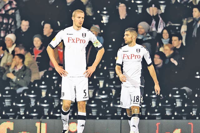 Brede Hangeland (left) and Aaron Hughes can hardly believe Fulham’s elimination