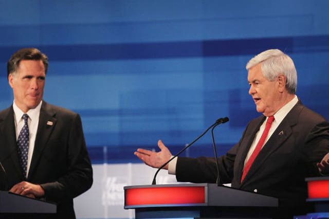 <p>Mitt Romney (left) listens as Newt Gingrich answers a question during last night's debate </p>
