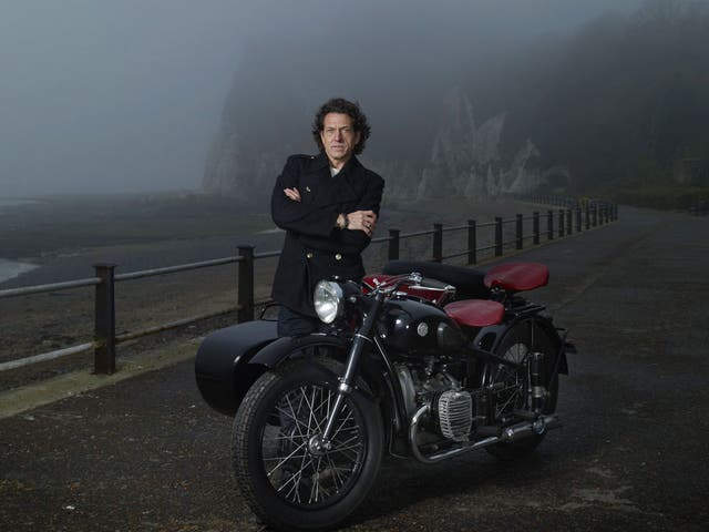 <p>Stephen Webster, photographed on the Kent coast, with his beloved motorcycle and sidecar</p>