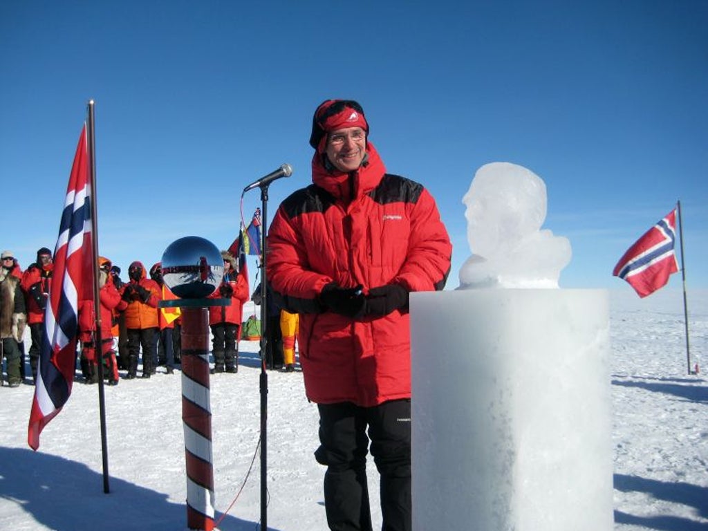The prime minister of Norway, Jens Stoltenberg, unveils an ice statue of Roald Amundsen at the South Pole