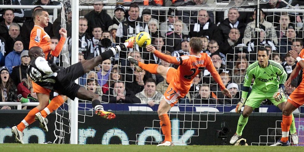 Everything Ba the goal: Newcastle striker Demba Ba tries to beat Michel Vorm with a spectacular attempt but the home side's pressure proves fruitless