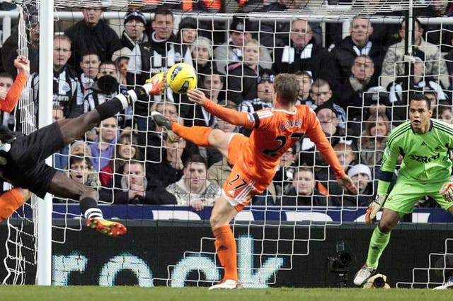 <p>Everything Ba the goal: Newcastle striker Demba Ba tries to beat Michel Vorm with a spectacular attempt but the home side's pressure proves fruitless</p>