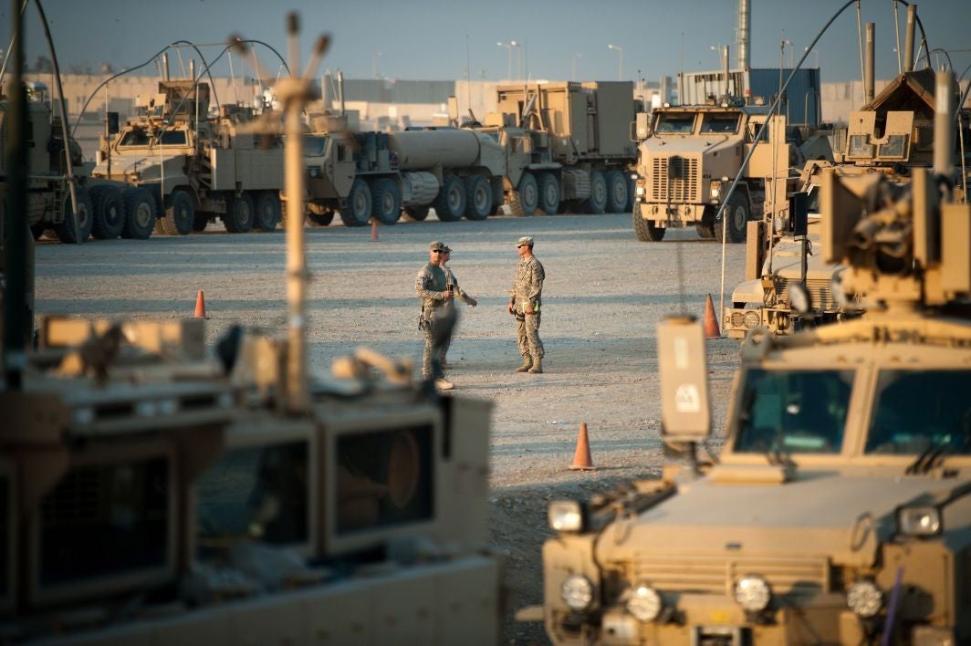Soldiers prepare the last convoy carrying US troops at Camp Adder on the outskirts of Nasiriyah, marking the withdrawal of US troops from Iraq