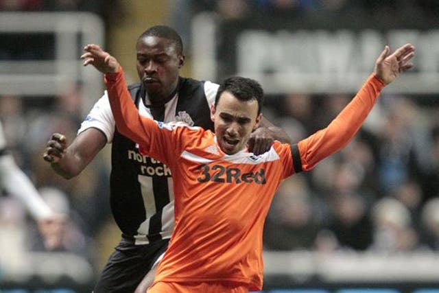 <p>Swansea's Leon Britton (front) is challenged by Newcastle's Shola Ameobi</p>
