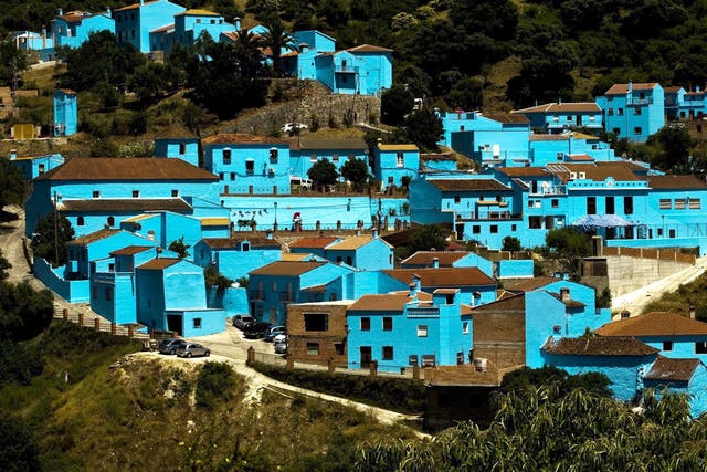 <p>After 175 buildings in Juzcar were painted 'Smurf blue' this summer, tourist numbers soared</p>