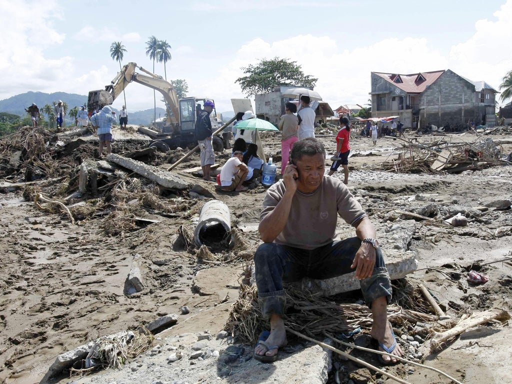 Workers search for victims of the floods in the coastal city of Iligan