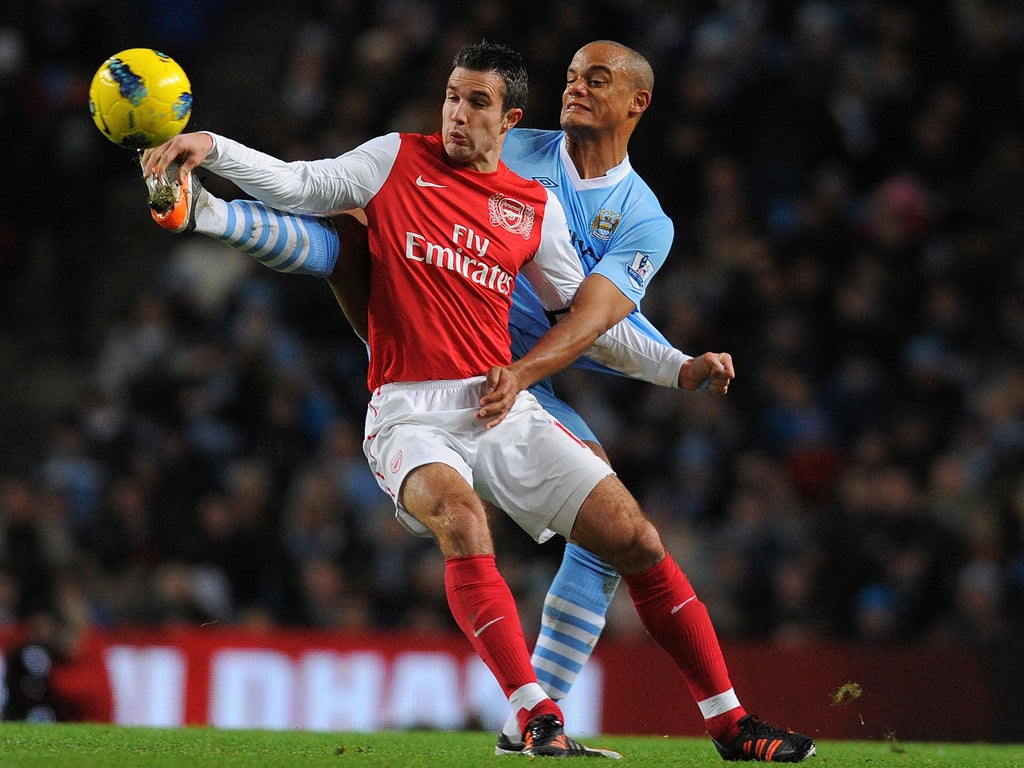 Robin van Persie gets in a tangle with Vincent Kompany