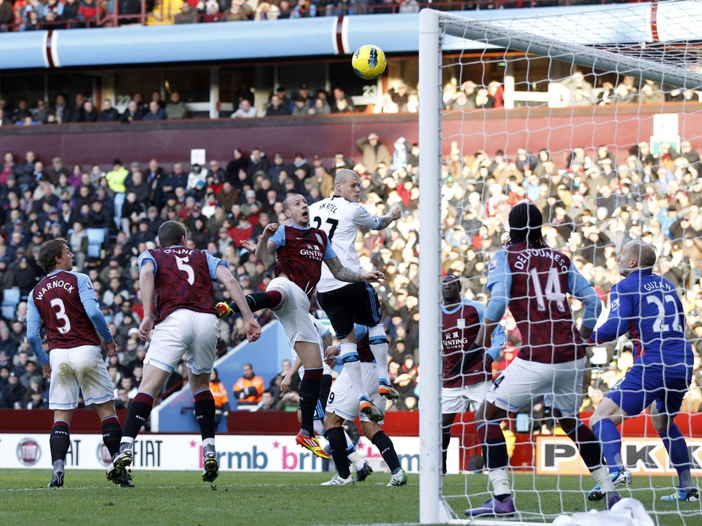 Martin Skrtel rises highest to head in Liverpool's second goal at Villa