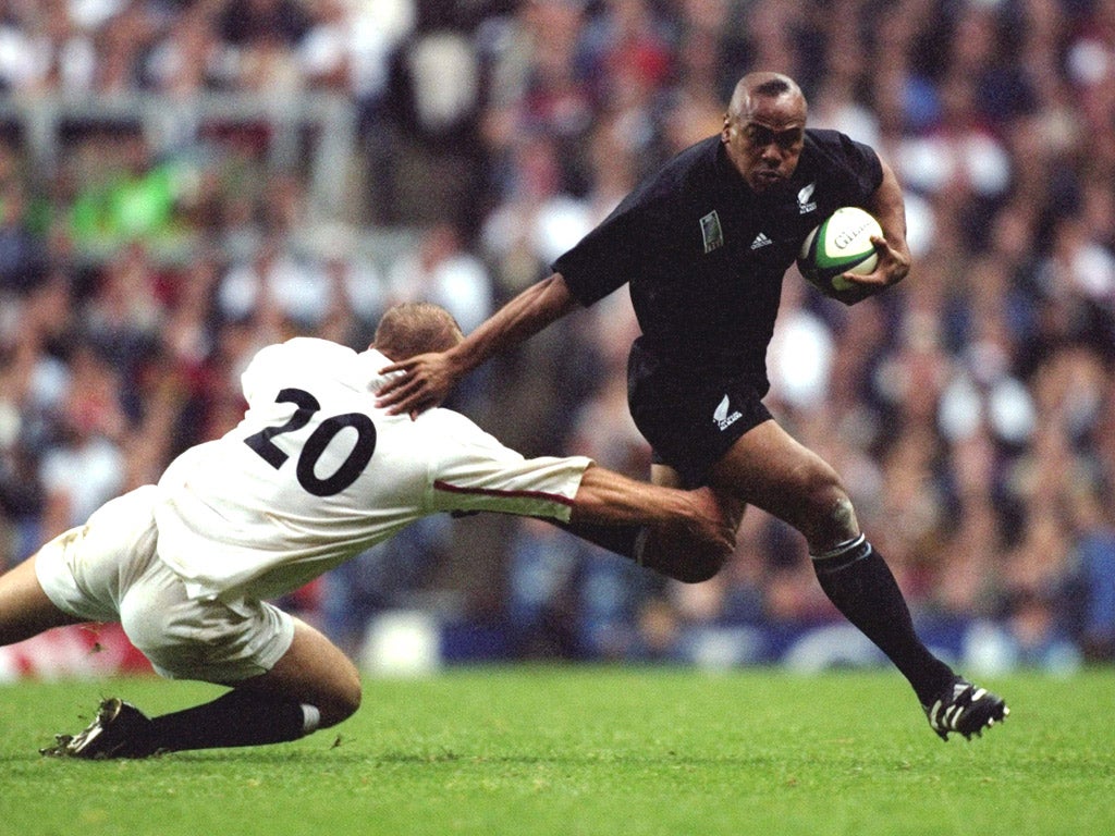 Jonah Lomu of New Zealand brushes aside Tim Rodber of England during the Rugby World Cup in 1999