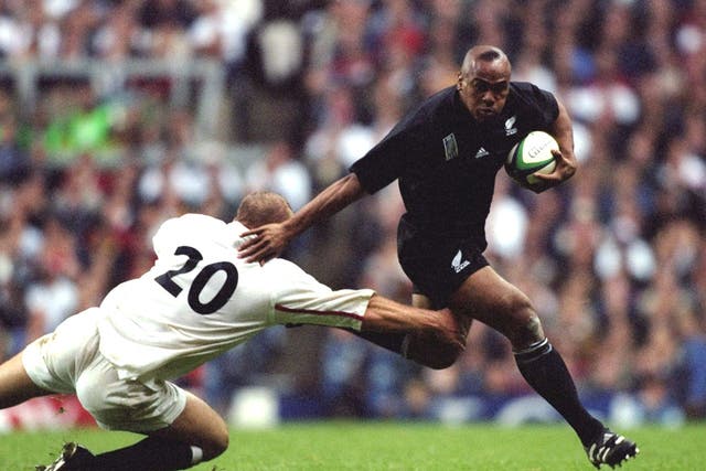 <p>Jonah Lomu of New Zealand  brushes aside Tim Rodber of  England during the Rugby World Cup in 1999</p>