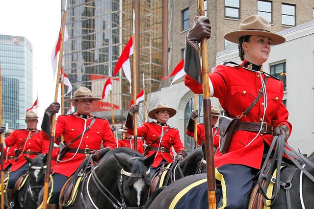 <p>Mounties stage a horseback parade through downtown Vancouver</p>