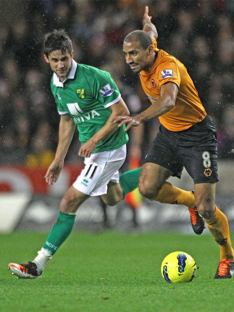 Andrew Surnam (left), who scored Norwich's first goal closes down the Wolves midfielder Karl Henry