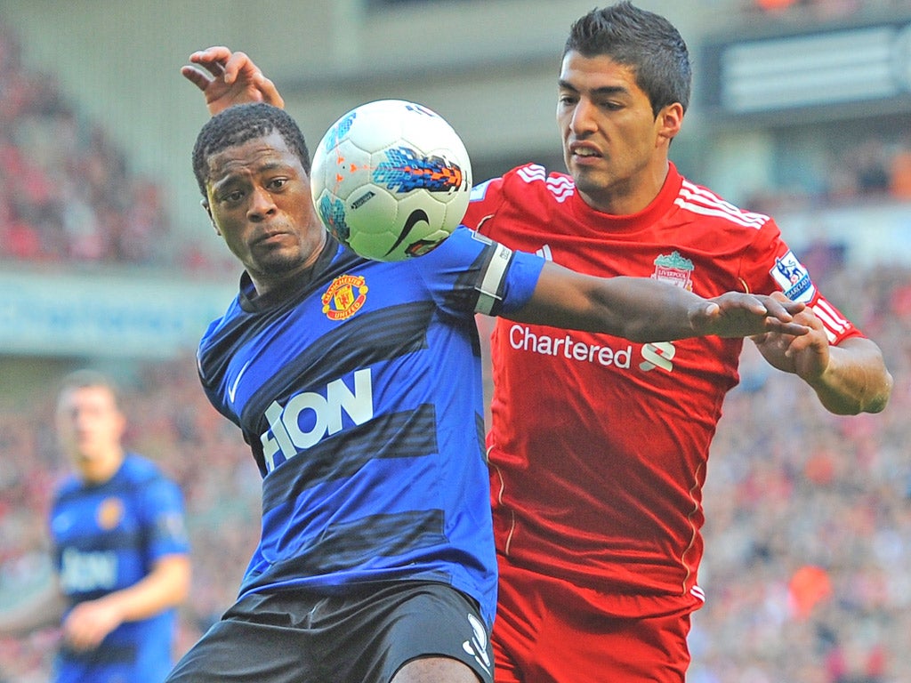 <p>Patrice Evra (left) and Luis Suarez tangle at Anfield in October leading up to their verbal confrontation</p>