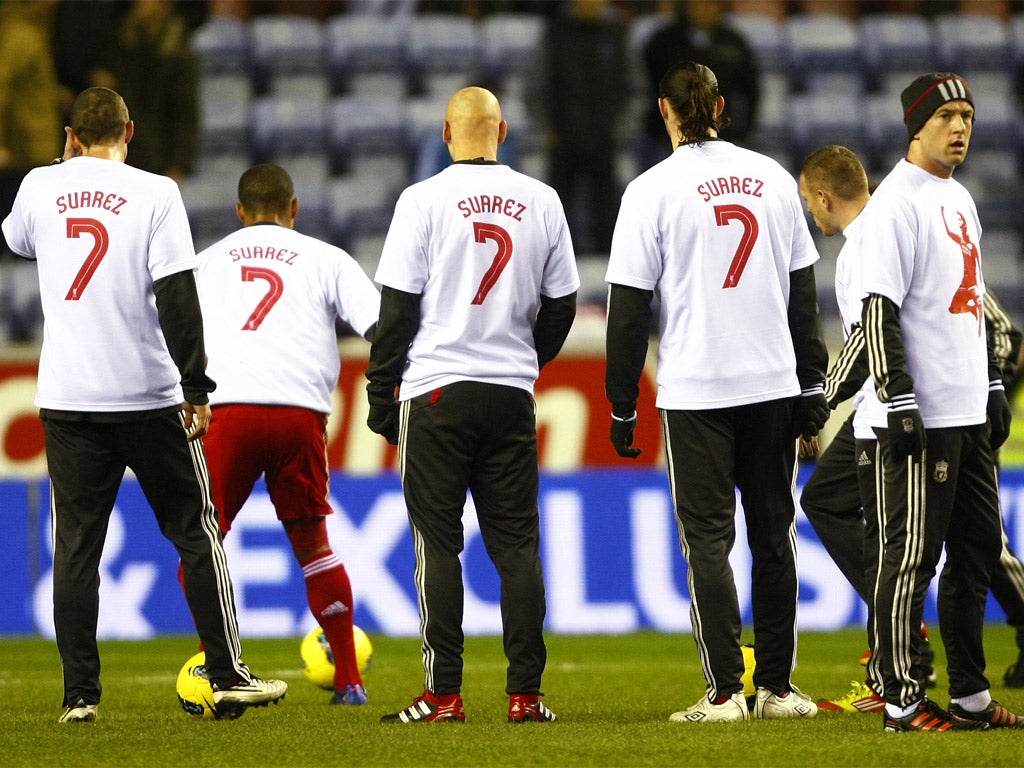 Liverpool players display their support for Luis Suarez