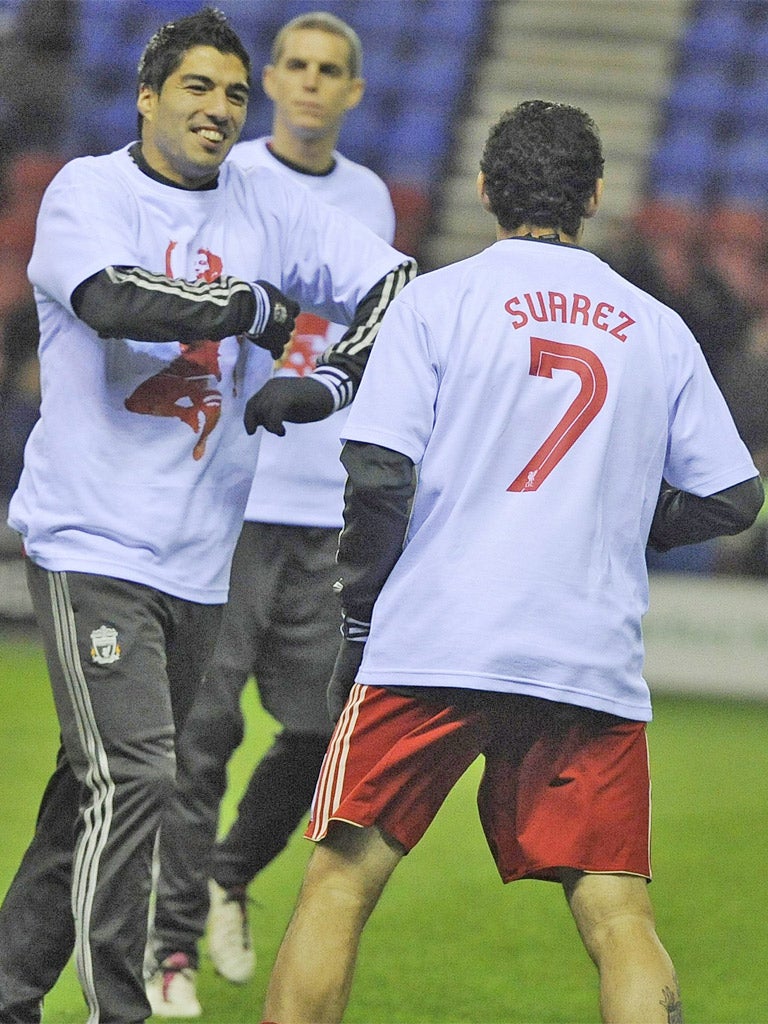 Luis Suarez is all smiles in the warm-up as his team-mates wear T-shirts supporting the Liverpool forward