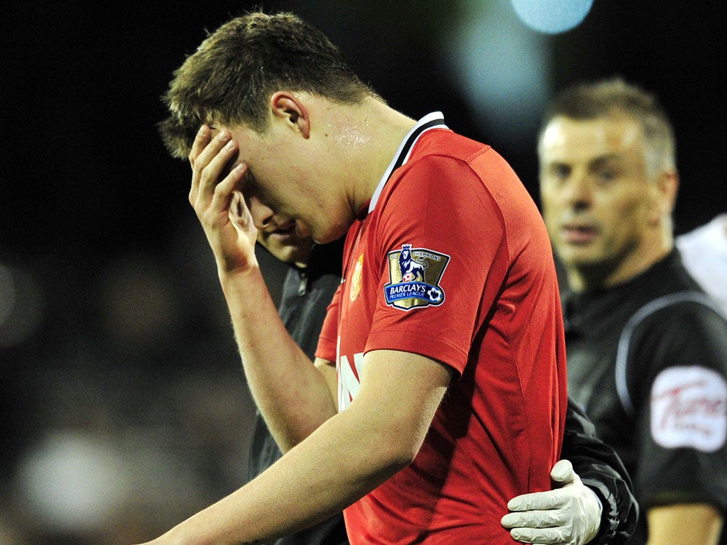 Phil Jones is taken off at Fulham after catching an elbow in his face