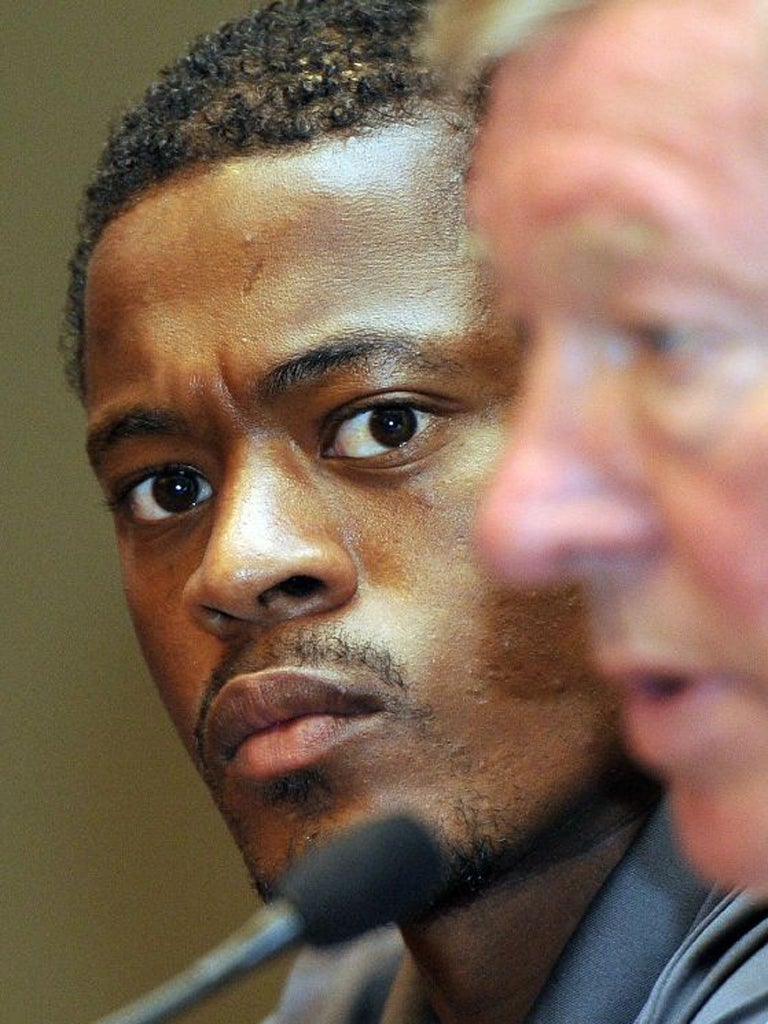 Patrice Evra - here alongside the Manchester United manager, Sir
Alex Ferguson - has faced racist abuse during his career