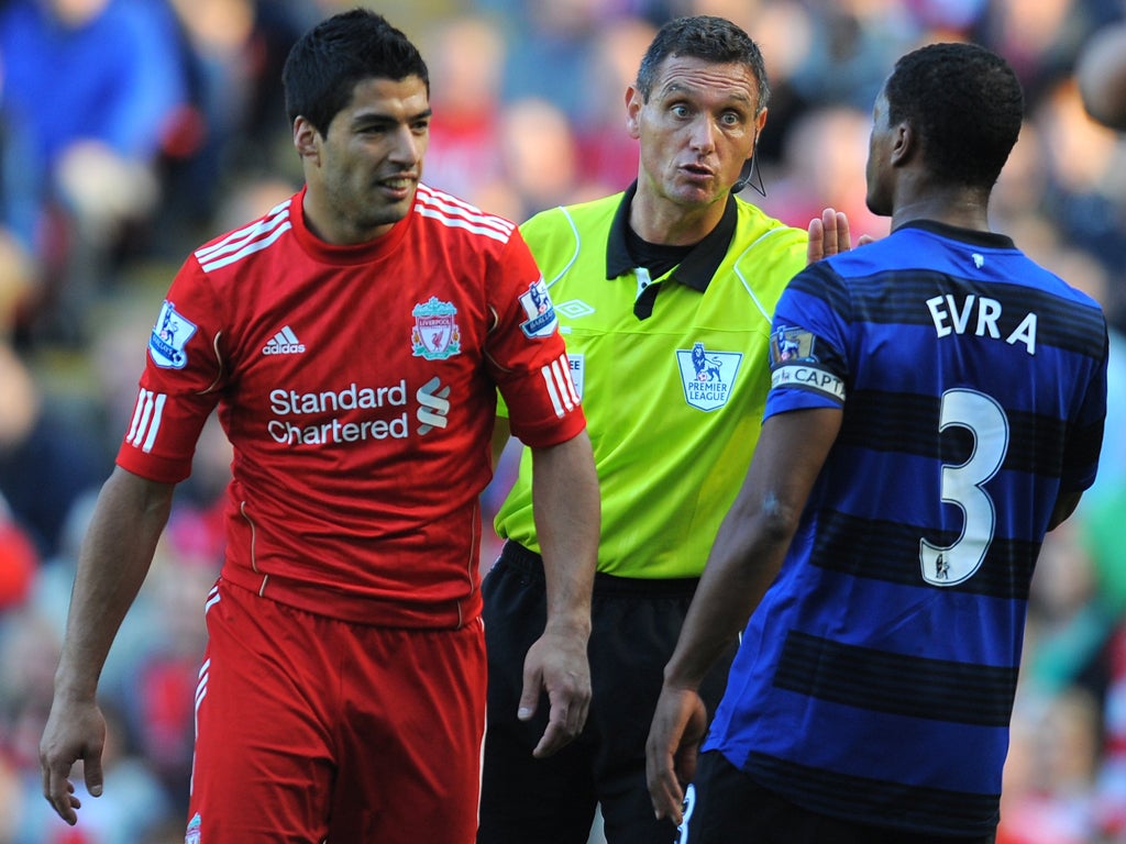 Manchester United's Patrice Evra and Liverpool's Luis Suarez clash
during the Premier League match at Anfield on 15 October