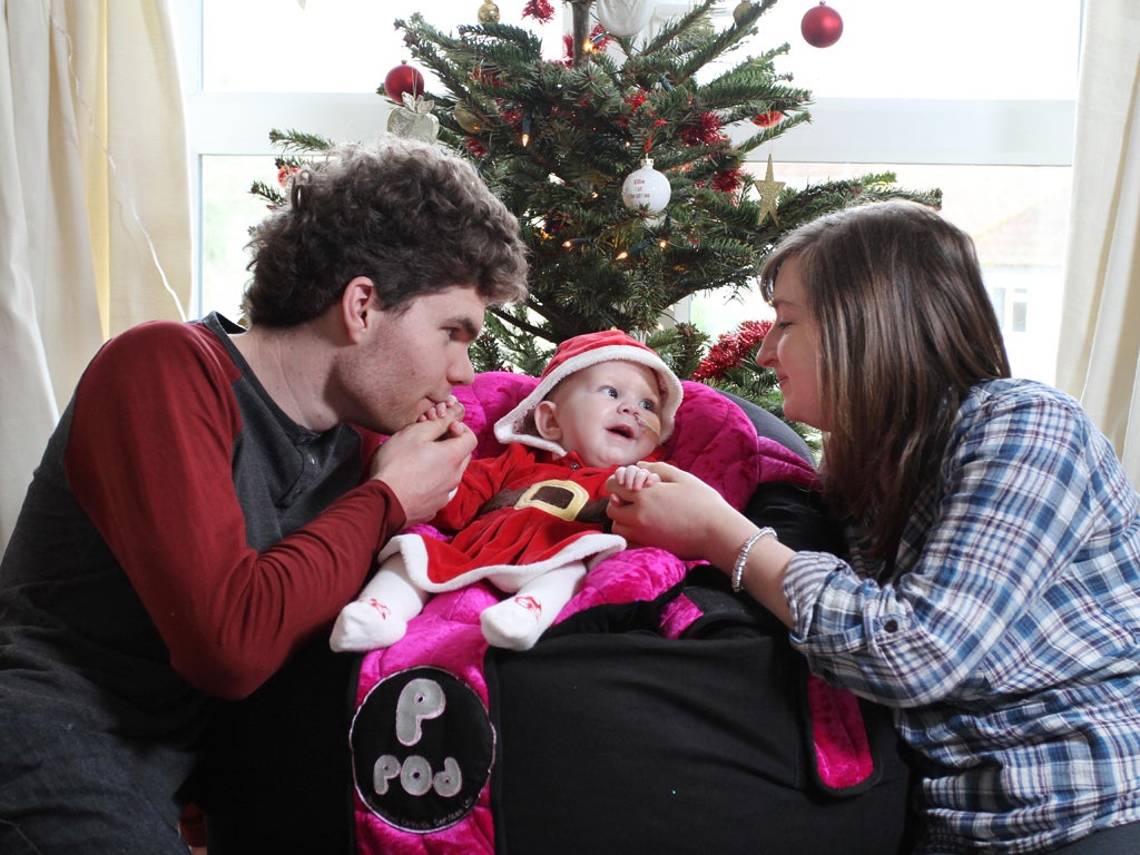 Six-month-old Ellie Taylor, who suffers from spinal muscular atrophy, with her parents, Dale and Yasmin
