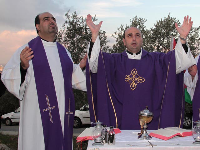 Palestinian Christian priests conduct prayers in Beit Jala in protest at the Israeli plans to extend the 470-mile security barrier through the town