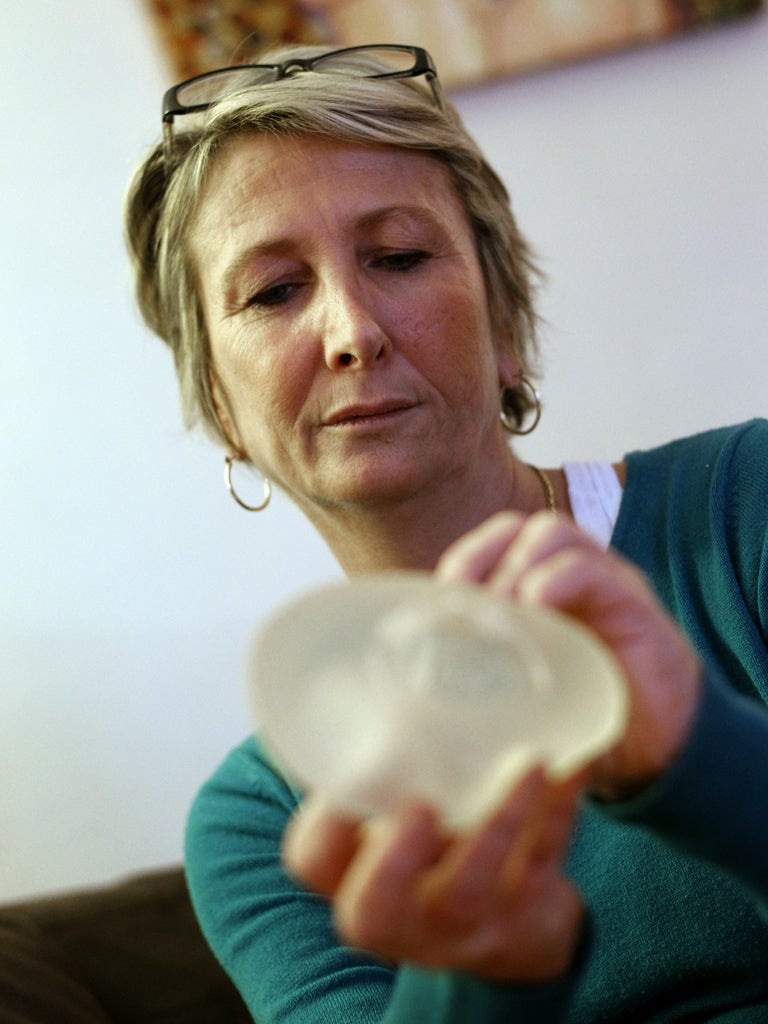 Chantal Guerin, 46, displays a breast implant made by PIP that she had removed