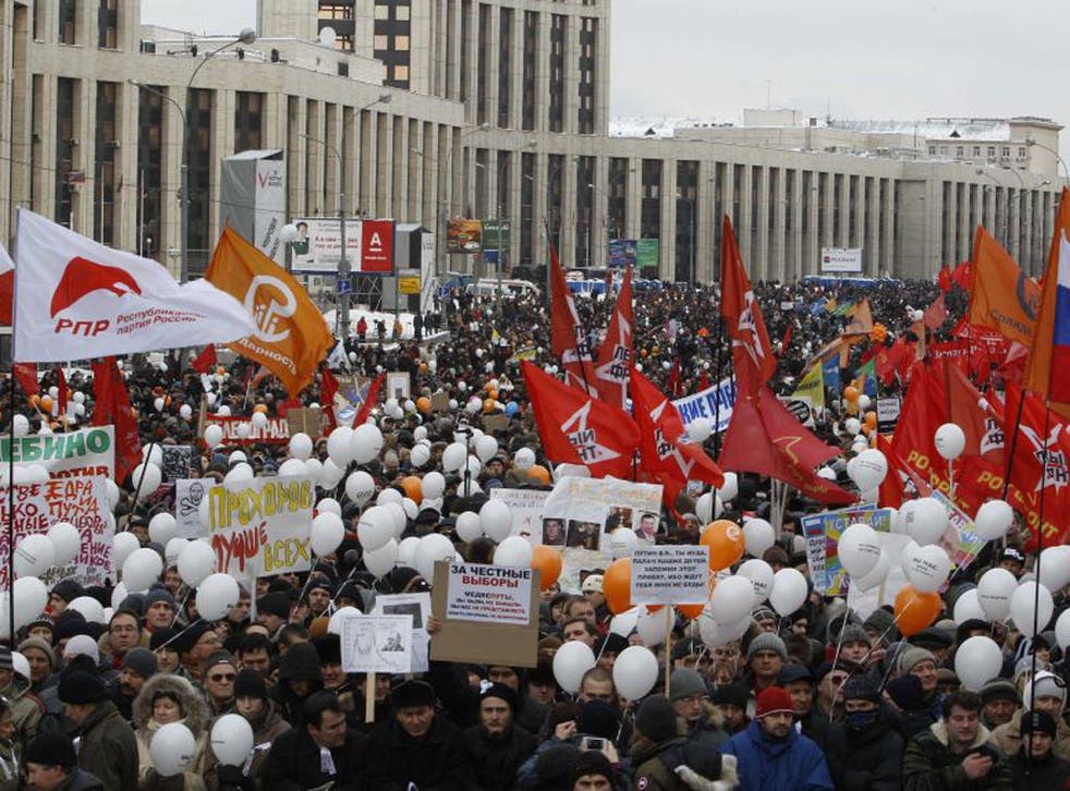 Demonstrators hold placards, flags and balloons during today's protest against recent parliamentary election results in Moscow 