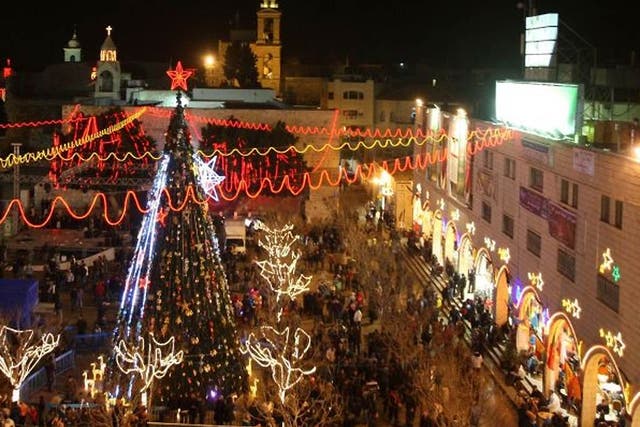 Crowds gather in Manger Square, next to the Church of the Nativity, as people ready to celebrate Christmas eve in the West Bank city of Bethlehem