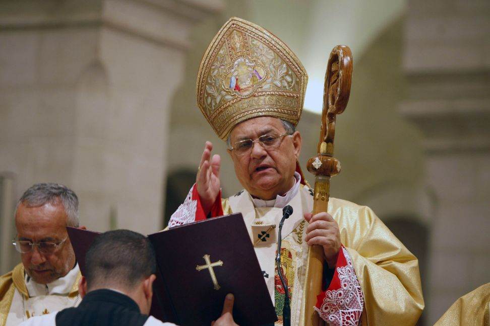 Latin Patriarch of Jerusalem Fouad Twal leads the Christmas midnight mass at the Church of the Nativity in Bethlehem
