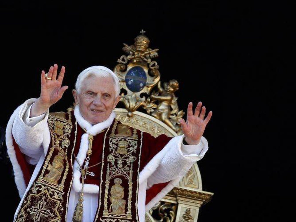 Pope Benedict XVI waves as he delivers Urbi et Orbi (to the city and the world) Christmas Day message from the central balcony of Saint Peter's Square at the Vatican
