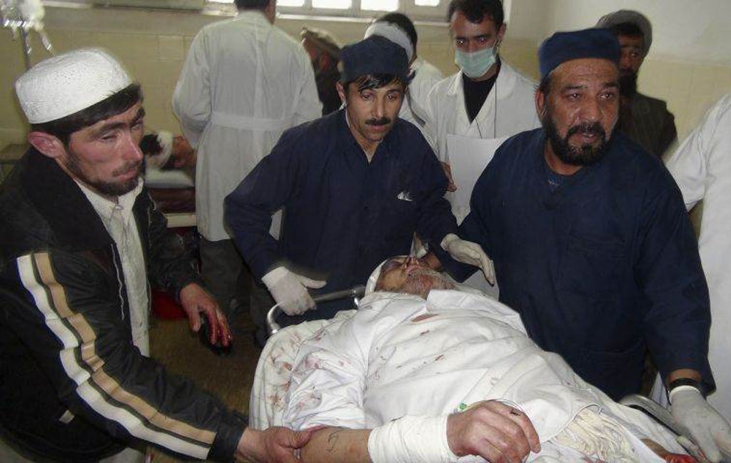 An injured Afghan man receives treatment at a hospital after a suicide attack in Takhar province