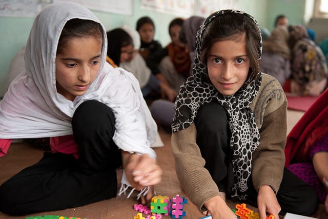 Young Afghan girls take a break from carrying out household
chores to attend a Save the Children outreach centre in Kabul