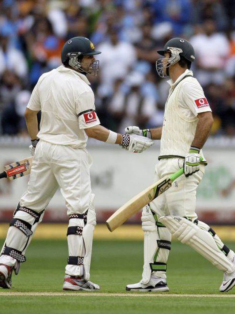 Rickey Ponting, right, of Australia is congratulated by teammate Ed Cowan