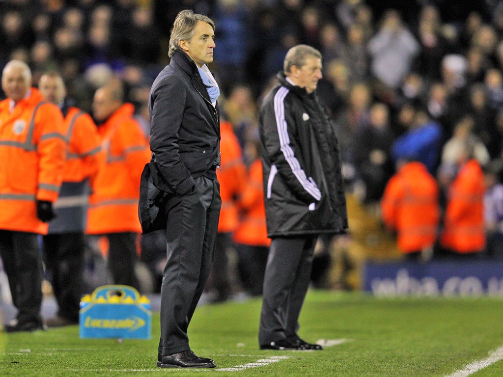 Roy Hodgson and Roberto Mancini look on during the Barclays Premier League match between West Bromwich Albion and Manchester City