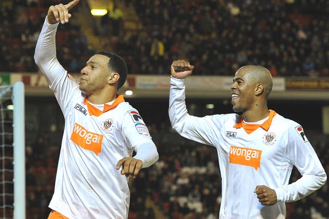 Blackpool’s Matt Phillips (left), who hit a hat-trick, and Ludovic Sylvestre celebrate the 3-1 win over Barnsley