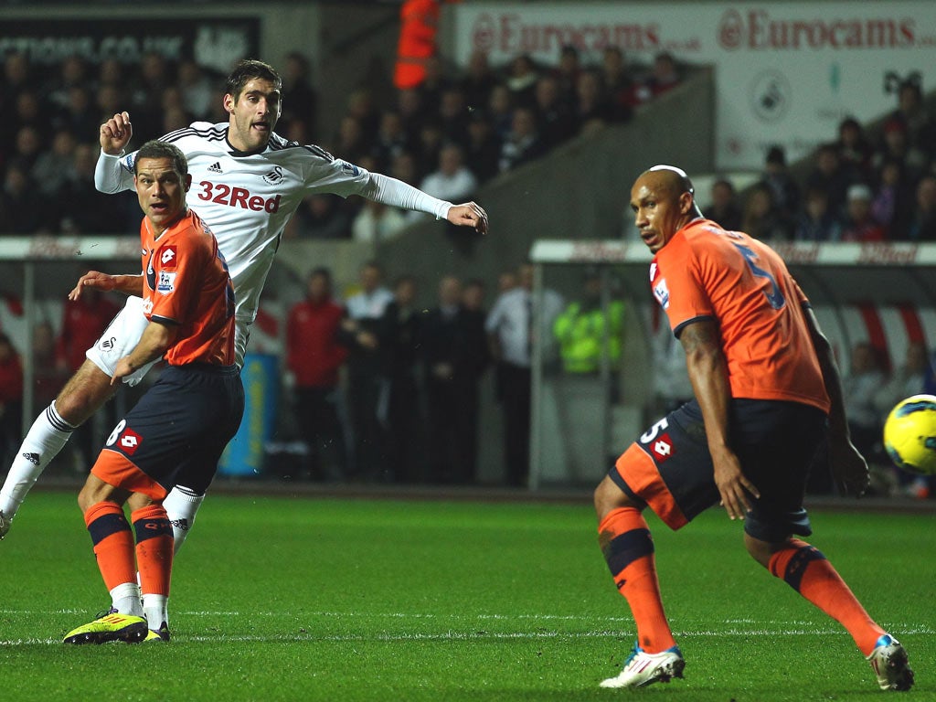 Danny Graham of Swansea scores the opening goal during the Barclays Premier League match