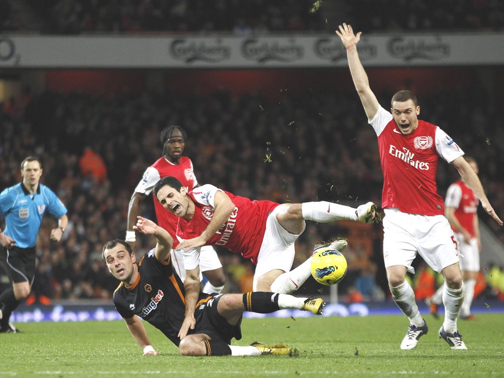 Nenad Milijas earns himself a red card for this tackle on Mikel
Arteta. Wolves will appeal