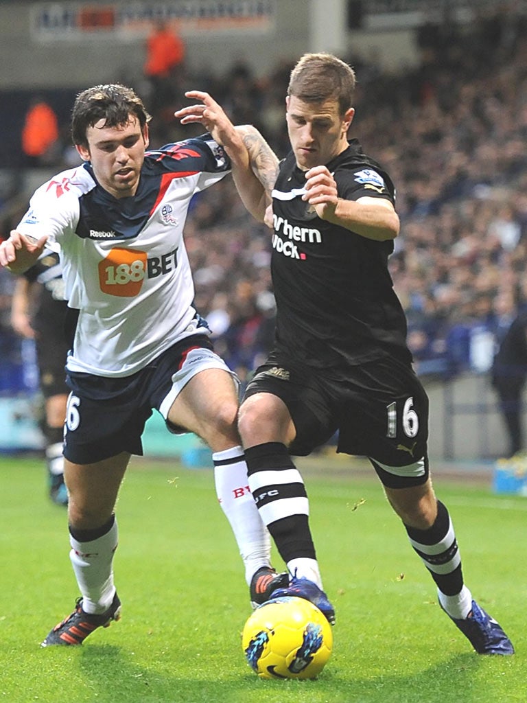 Bolton’s Mark Davies (left) fights for the ball with Newcastle’s Ryan Taylor at the Reebok Stadium