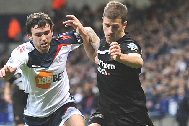 Bolton’s Mark Davies (left) fights for the ball with Newcastle’s Ryan Taylor at the Reebok Stadium
