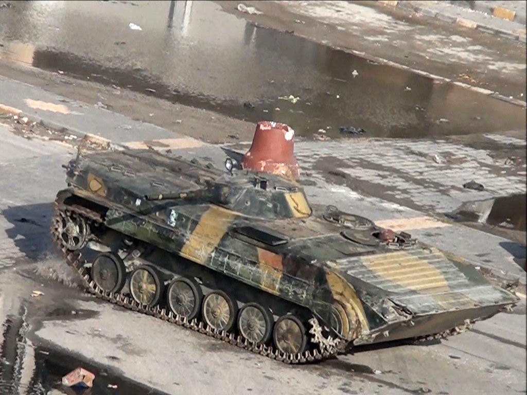 A Syrian tank is seen in this video grab driving through the
city of Homs on Boxing Day