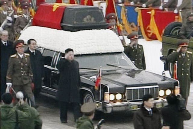 In this image made from KRT video, North Korean successor Kim Jong Un salutes as the funeral procession of late leader Kim Jong Il returned to the Kumsusan Memorial Palace in Pyongyang