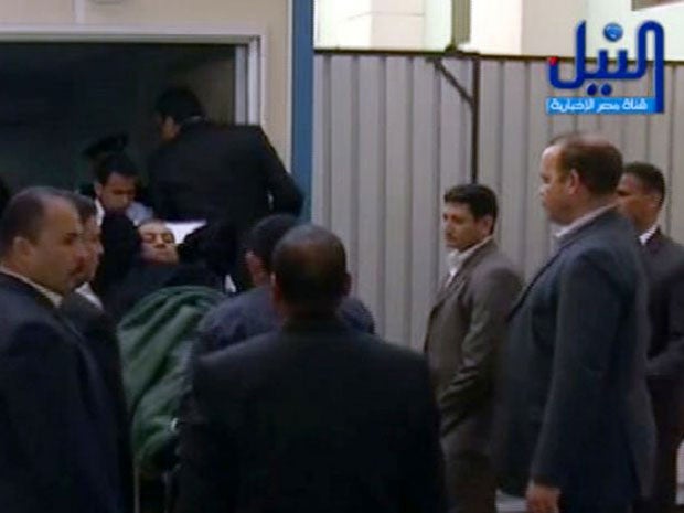 Hosni Mubarak is wheeled wheeled on a hospital stretcher into court for the resumption of his trial