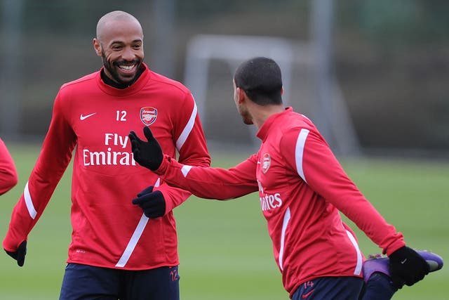 Thierry Henry (left) trains with Theo Walcott at London Colney yesterday