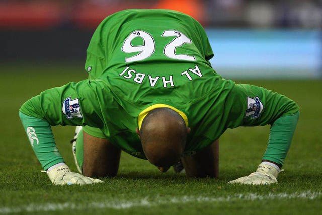 Wigan Athletic goalkeeper Ali Al-Habsi kisses the turf as his team earn an unlikely point at Stoke