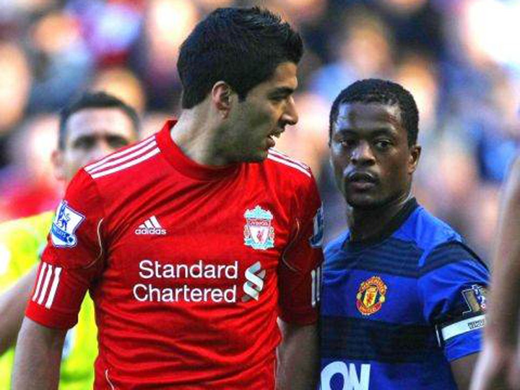 Luis Suarez (left) exchanges words with Patrice Evra at Anfield