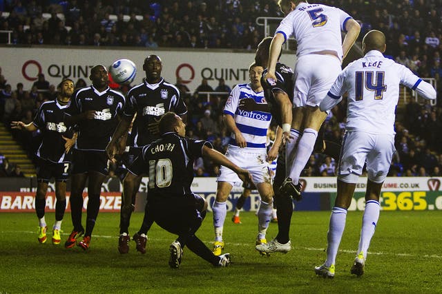 Reading’s Alex Pearce heads the only goal of the game against Ipswich