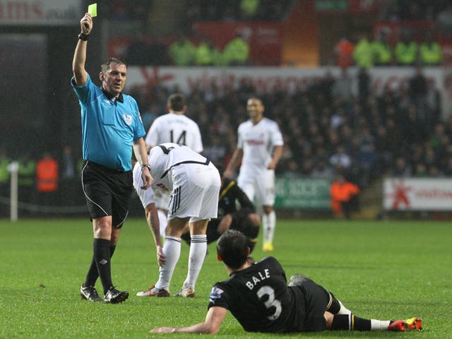 Referee Phil Dowd books Gareth Bale for diving on a frustrating day for Tottenham at the Liberty Stadium