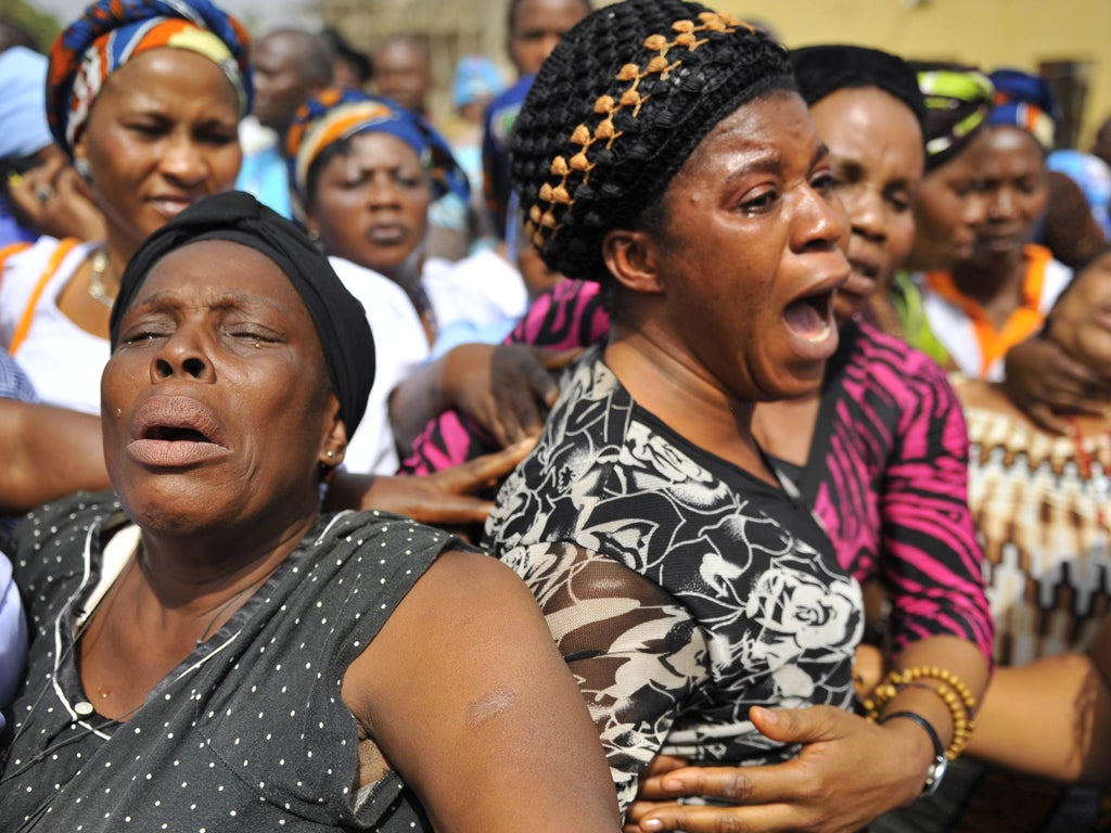 Mourners at a church that was bombed in Madalla, outside Abuja